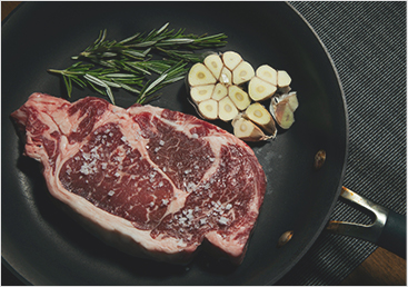 Steak in a pan being cooked